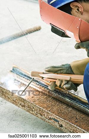 Construction worker working at construction site, close-up View Large Photo Image Stock Image - Construction worker working at construction site, close-up. Fotosearch