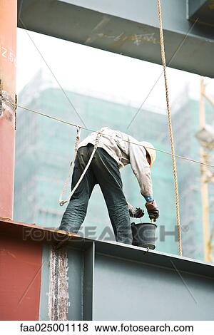 Construction worker working at construction site View Large Photo Image Stock Photo - Construction worker working at construction site. Fotosearch
