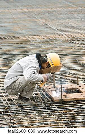 Construction worker working at construction site View Large Photo Image Stock Photograph - Construction worker working at construction site. Fotosearch