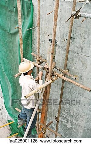 Stock Photograph - Construction worker working at construction site. Fotosearch