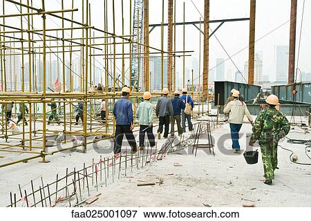 Stock Photo - Construction workers leaving construction site. Fotosearch