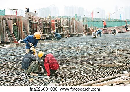 Construction workers working at construction site View Large Photo Image Stock Image - Construction workers working at construction site. Fotosearch