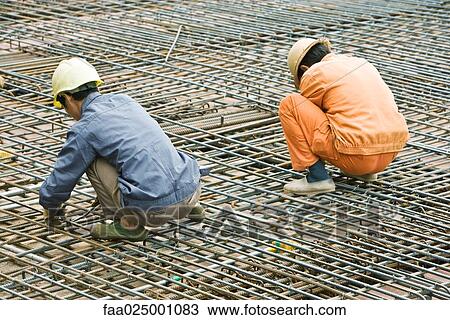 Construction workers working at construction site View Large Photo Image Stock Image - Construction workers working at construction site. Fotosearch