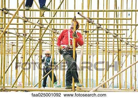 Construction workers working at construction site View Large Photo Image Stock Image - Construction workers working at construction site. Fotosearch