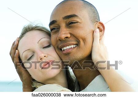 Couple embracing, cheek to cheek, close-up View Large Photo Image Stock Photo - Couple embracing, cheek to cheek, close-up. Fotosearch