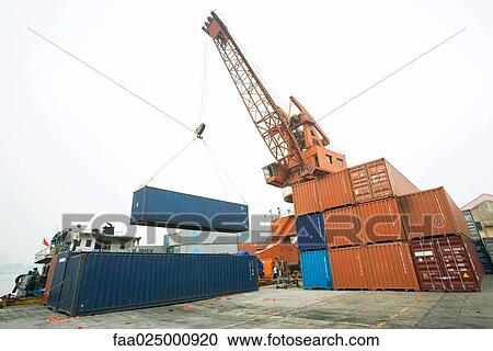 Crane picking up cargo container View Large Photo Image Stock Image - Crane picking up cargo container. Fotosearch