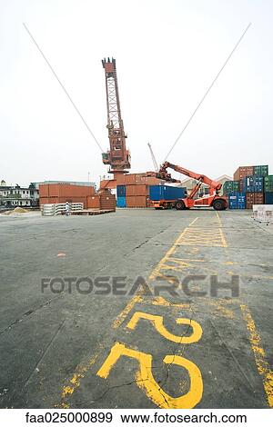 Cranes and cargo containers in shipyard View Large Photo Image Stock Photo - Cranes and cargo containers in shipyard. Fotosearch
