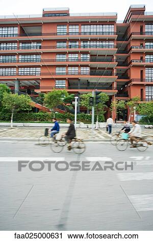 Cyclists riding in street, blurred motion View Large Photo Image Stock Image - Cyclists riding in street, blurred motion. Fotosearch