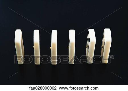 Stock Image - Dominoes in a row, close-up. Fotosearch