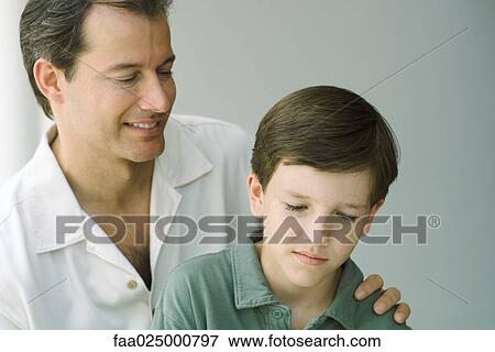 Father and son looking down and smiling together, close-up View Large Photo Image Stock Photo - Father and son looking down and smiling together, close-up. Fotosearch