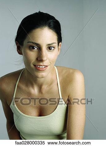 Female in tank top smiling at camera, portrait View Large Photo Image Stock Photography - Female in tank top smiling at camera, portrait. Fotosearch
