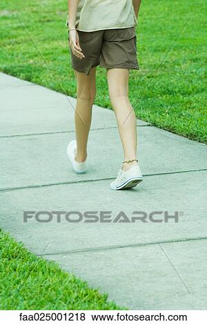 Female walking on sidewalk, waist down, rear view View Large Photo Image Stock Photo - Female walking on sidewalk, waist down, rear view. Fotosearch
