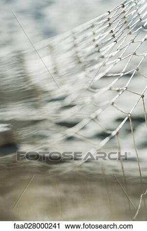 Fishing net over water, close-up View Large Photo Image Stock Image - Fishing net over water, close-up. Fotosearch