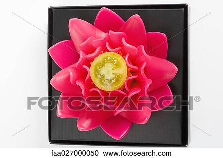 Flower with yellow tomato in center, close-up View Large Photo Image Stock Image - Flower with yellow tomato in center, close-up. Fotosearch