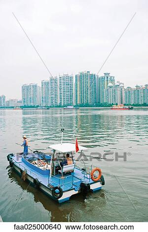 Garbage boat cleaning river View Large Photo Image Stock Image - Garbage boat cleaning river. Fotosearch