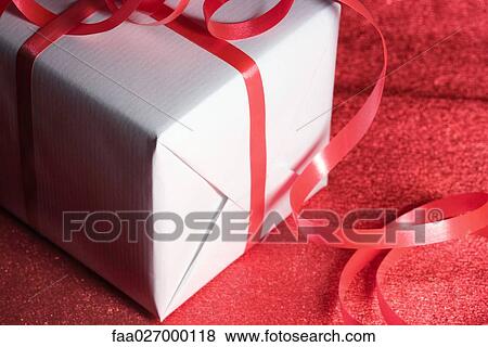 Gift wrapped in ribbon, close-up View Large Photo Image Stock Photo - Gift wrapped in ribbon, close-up. Fotosearch