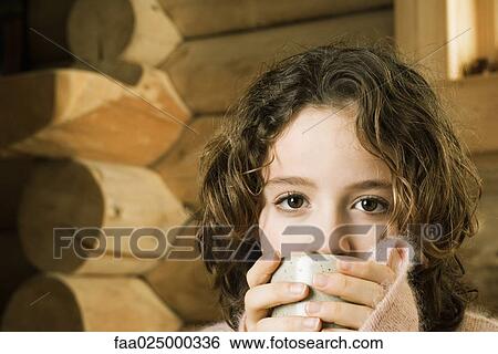 Girl drinking from mug View Large Photo Image Stock Photograph - Girl drinking from mug. Fotosearch