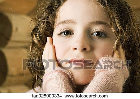 Girl holding head in hands, portrait View Large Photo Image Picture - Girl holding head in hands, portrait. Fotosearch