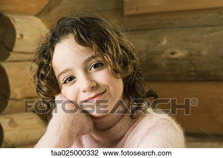 Girl leaning head on hand, smiling at camera View Large Photo Image Stock Image - Girl leaning head on hand, smiling at camera. Fotosearch