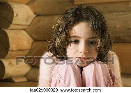 Girl resting head on knees, looking away View Large Photo Image Stock Photo - Girl resting head on knees, looking away. Fotosearch