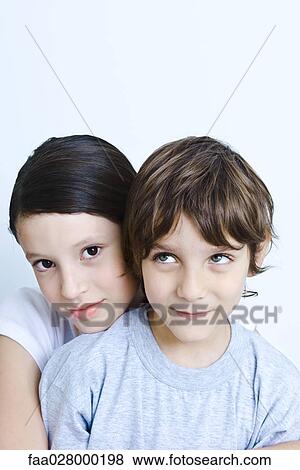 Girl resting her head on younger brother's shoulder, smiling at camera, portrait View Large Photo Image Stock Photo - Girl resting her head on younger brother's shoulder, smiling at camera, portrait. Fotosearch