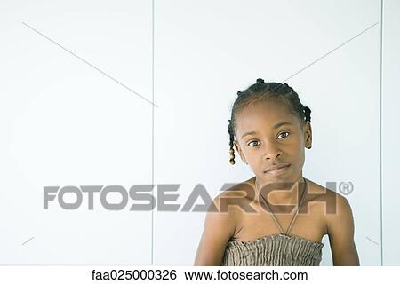 Stock Photograph - Girl smiling at camera, head tilted, portrait. Fotosearch