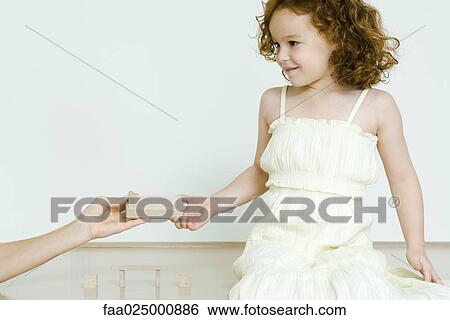 Girl taking wooden block View Large Photo Image Stock Photograph - Girl taking wooden block. Fotosearch