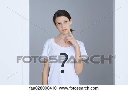 Girl wearing tee-shirt printed with question mark, touching face, looking up View Large Photo Image Stock Image - Girl wearing tee-shirt printed with question mark, touching face, looking up. Fotosearch