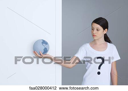 Girl wearing tee-shirt printed with question mark, looking at globe View Large Photo Image Stock Image - Girl wearing tee-shirt printed with question mark, looking at globe. Fotosearch