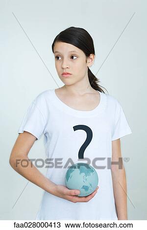 Girl wearing tee-shirt printed with question mark, holding globe, looking away View Large Photo Image Stock Image - Girl wearing tee-shirt printed with question mark, holding globe, looking away. Fotosearch