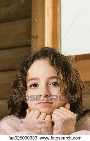 Girl with hands under chin, portrait View Large Photo Image Stock Image - Girl with hands under chin, portrait. Fotosearch