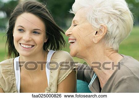 Stock Photograph - Grandmother and teenage granddaughter smiling and laughing together, close-up. Fotosearch