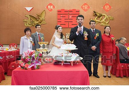 Groom standing in front of bride and parents, speaking into microphone View Large Photo Image Stock Photography - Groom standing in front of bride and parents, speaking into microphone. Fotosearch