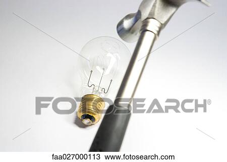 Hammer over lightbulb, close-up View Large Photo Image Stock Image - Hammer over lightbulb, close-up. Fotosearch
