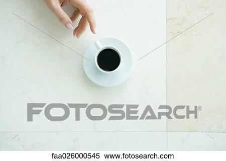 Hand reaching for coffee cup, viewed from directly above View Large Photo Image Stock Photography - Hand reaching for coffee cup, viewed from directly above. Fotosearch