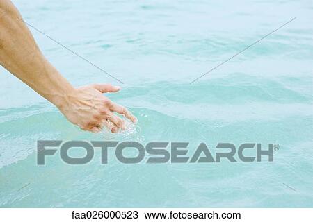 Hand touching water, close-up View Large Photo Image Stock Image - Hand touching water, close-up. Fotosearch