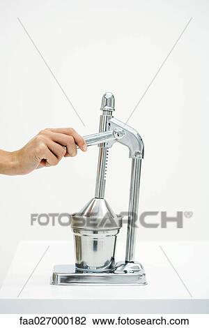 Hand using chrome juicer, cropped view View Large Photo Image Stock Image - Hand using chrome juicer, cropped view. Fotosearch