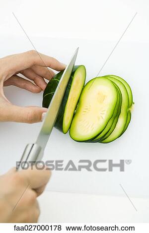 Hands cutting summer squash (zapallito redondo), with knife, cropped view View Large Photo Image Stock Photo - Hands cutting summer squash (zapallito redondo), with knife, cropped view. Fotosearch