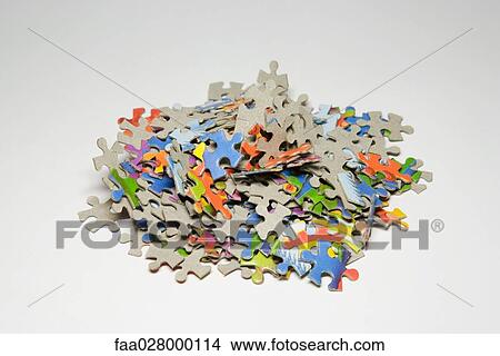 Jigsaw puzzle pieces in a pile, close-up View Large Photo Image Picture - Jigsaw puzzle pieces in a pile, close-up. Fotosearch