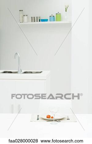 Kitchen interior with table and place setting, cherry tomatoes on plate View Large Photo Image Stock Photo - Kitchen interior with table and place setting, cherry tomatoes on plate. Fotosearch