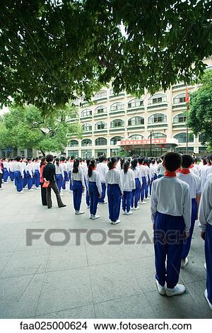 Large group of students in uniform standing in square, rear view View Large Photo Image Picture - Large group of students in uniform standing in square, rear view. Fotosearch