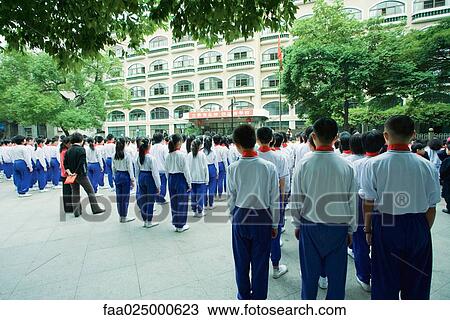 Large group of students in uniform standing in square, rear view View Large Photo Image Stock Image - Large group of students in uniform standing in square, rear view. Fotosearch