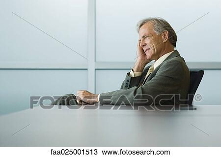 leaning against, businessman, looking away, holding head, clenching teeth, worry View Large Photo Image Stock Image - leaning against, businessman, looking away, holding head, clenching teeth, worry. Fotosearch