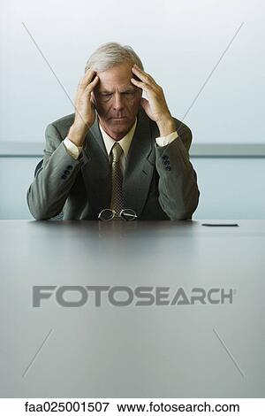 leaning on elbow, headache, businessman, furrowing brow, looking down, holding head View Large Photo Image Stock Photo - leaning on elbow, headache, businessman, furrowing brow, looking down, holding head. Fotosearch