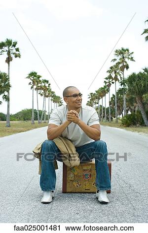 leaning on elbow, sitting, suitcase, road, hitchhiker, on top of View Large Photo Image Stock Image - leaning on elbow, sitting, suitcase, road, hitchhiker, on top of. Fotosearch