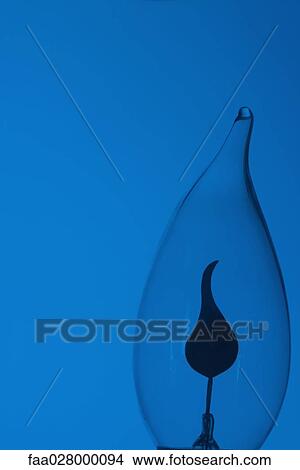 Light bulb and blue background, close-up View Large Photo Image Picture - Light bulb and blue background, close-up. Fotosearch