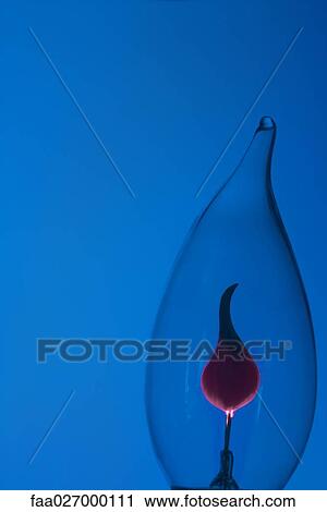 Lightbulb against blue background, close-up View Large Photo Image Stock Image - Lightbulb against blue background, close-up. Fotosearch