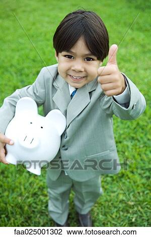 Little boy dressed in full suit holding piggy bank, giving thumbs up signal to camera, smiling View Large Photo Image Stock Image - Little boy dressed in full suit holding piggy bank, giving thumbs up signal to camera, smiling. Fotosearch