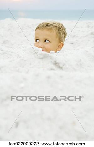 Little boy hiding in sand at the beach, looking away View Large Photo Image Stock Image - Little boy hiding in sand at the beach, looking away. Fotosearch
