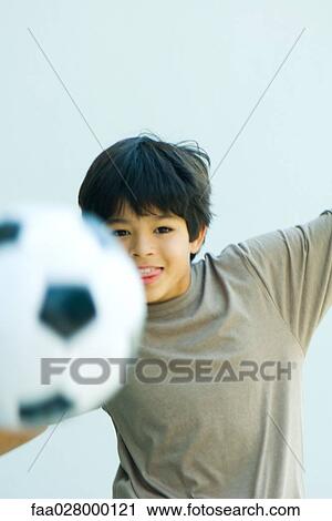 Little boy playing with soccer ball, arms out, smiling at camera View Large Photo Image Stock Image - Little boy playing with soccer ball, arms out, smiling at camera. Fotosearch